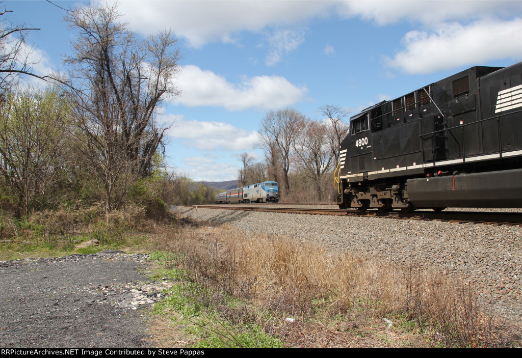 Amtrak 109 takes train 42 through Cove PA, while some engines wait on the siding